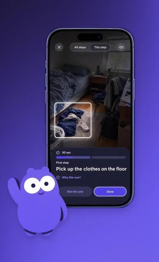 The Mopkin app showing a bedroom photo with a spotlight on clothes on the floor, the task “Pick up the clothes on the floor, 30 sec” and Done and Not this one buttons, while Mopkin waves.